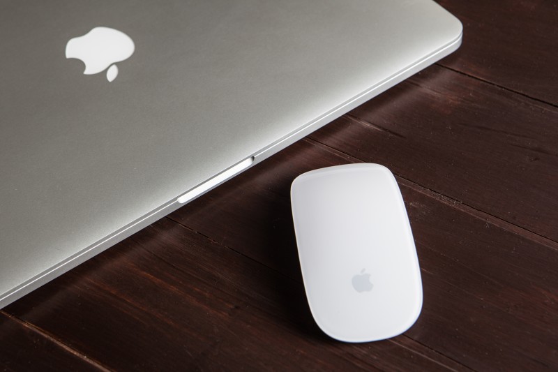 A photo of a macbook and a mac mouse